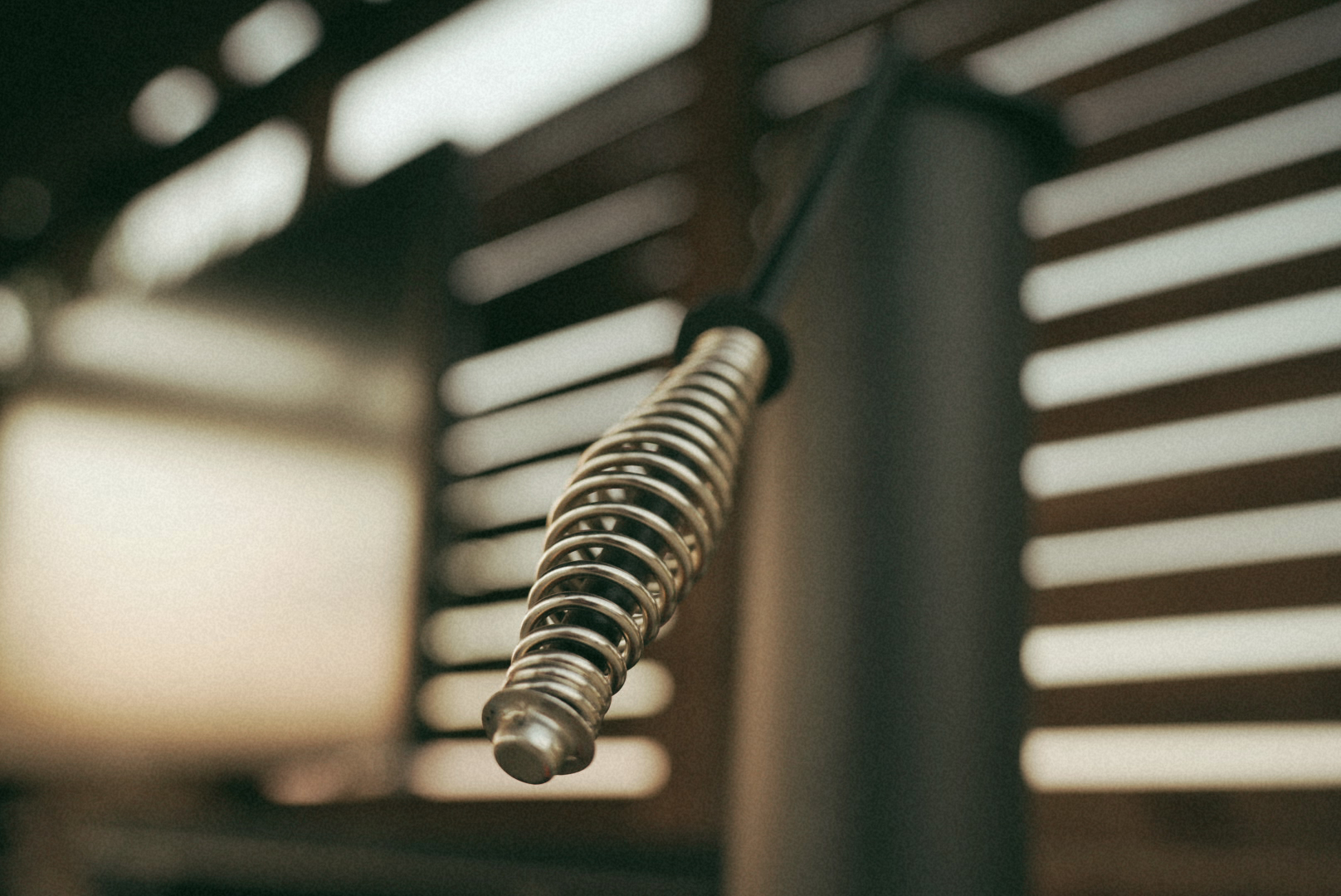 Yoder smoker spring handle against the slatted outdoor kitchen